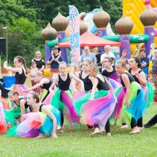 A group of children dancing in tutus