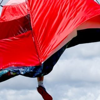 A banner image shows a red tent floating against a cloudy blue sky.